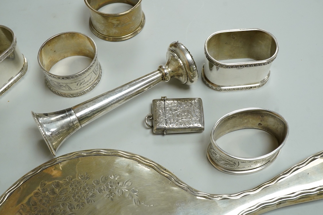 Three assorted silver napkin rings, a pair of recent 925 napkin rings, a George V silver mounted hand mirror, a modern silver mounted spill vase and a late Victorian silver vesta case.